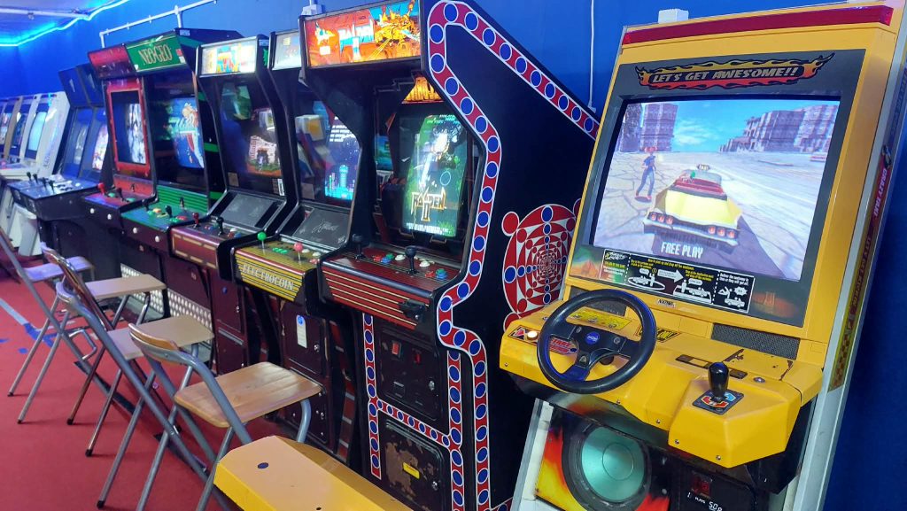 Row of upright cabinets including Neo Geo, Raiden and Crazy Taxi