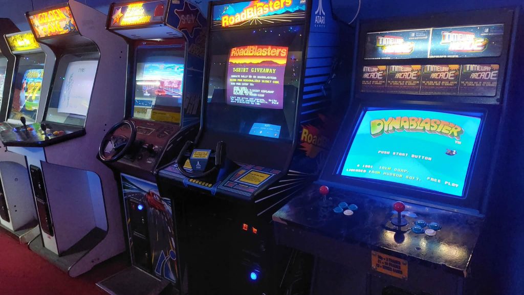 Golden Axe, RoadBlasters and Dynablaster cabinets lit up on the arcade floor