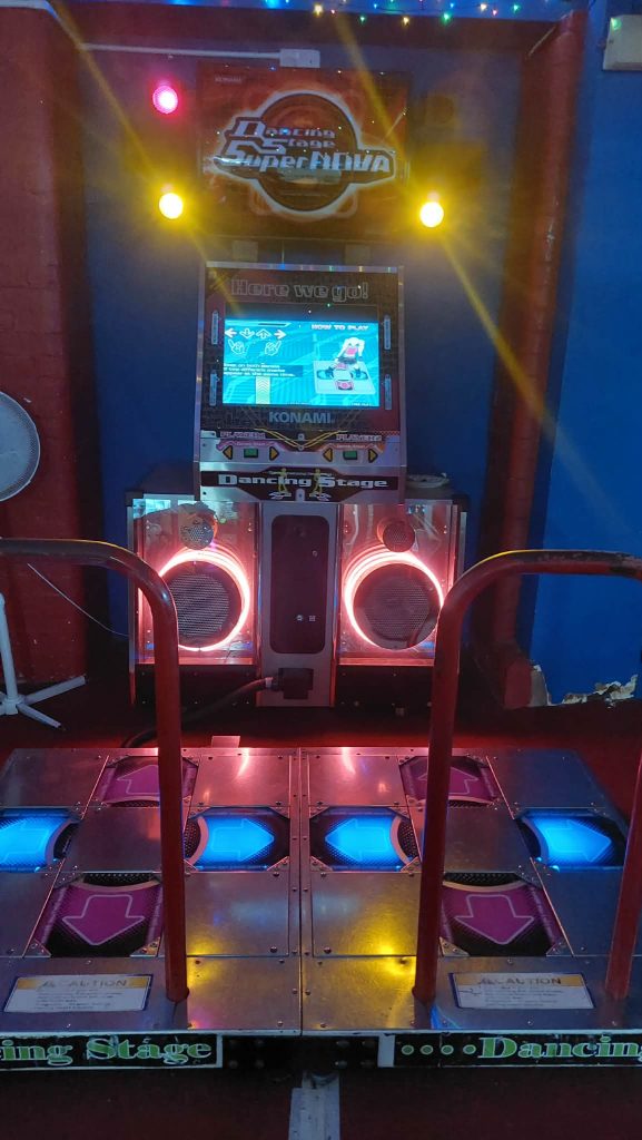 Konami Dancing Stage SuperNOVA 2 machine with its dance pads lit up
