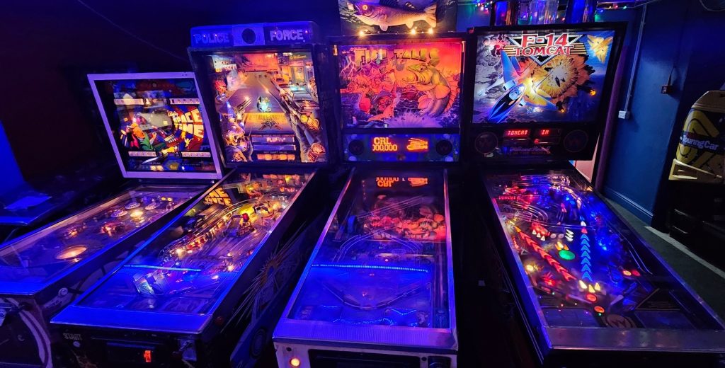 Row of pinball tables including Space Time, Police Force, Fish Tales and F-14 Tomcat