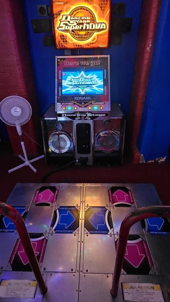 Konami Dancing Stage SuperNOVA 2 machine with lit dance pads