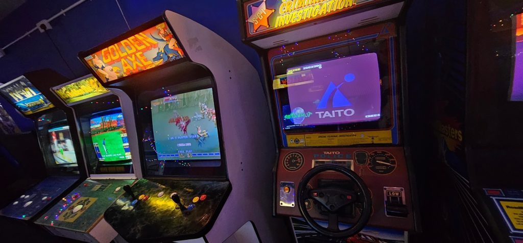 Golden Axe and Taito S.C.I. cabinets on the arcade floor