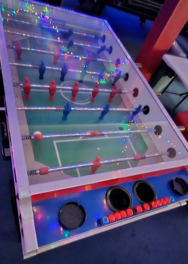 Table football table under the arcade fairy lights