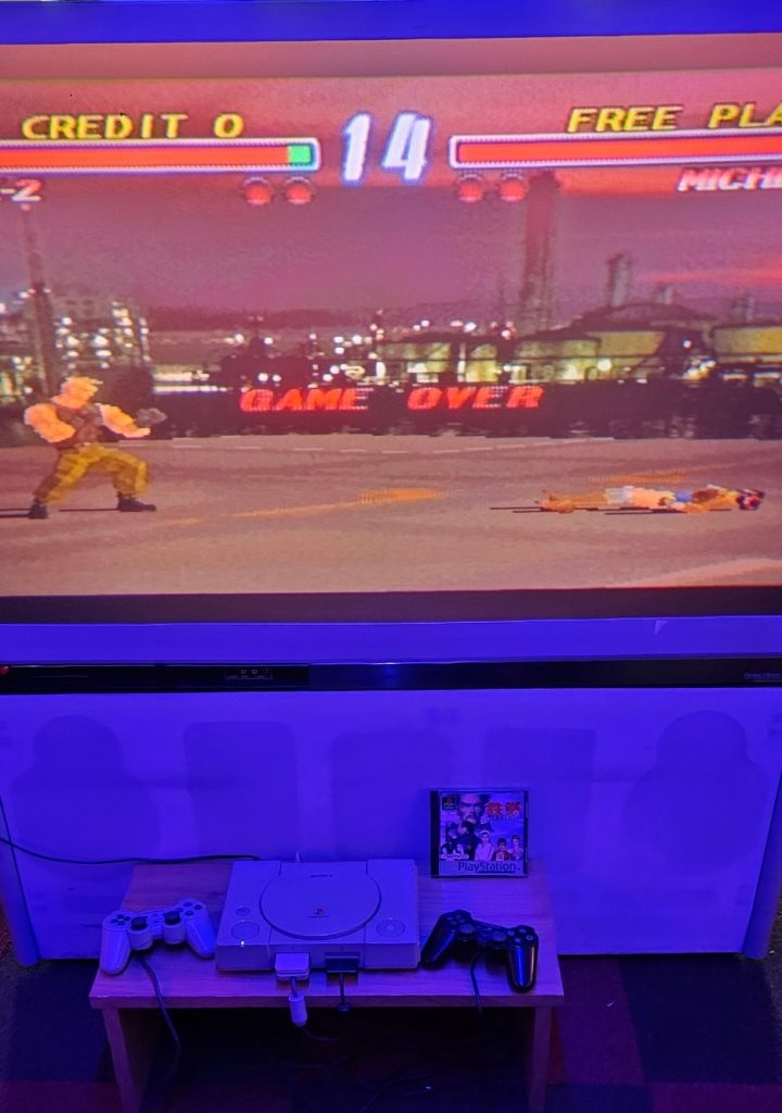 Original PlayStation set up with Tekken on a large screen
