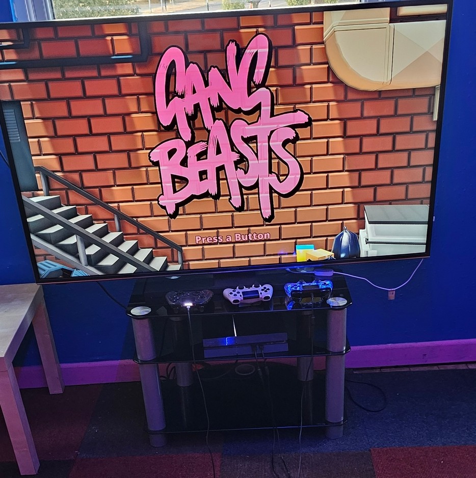 Gang Beasts on a console with three controllers ready