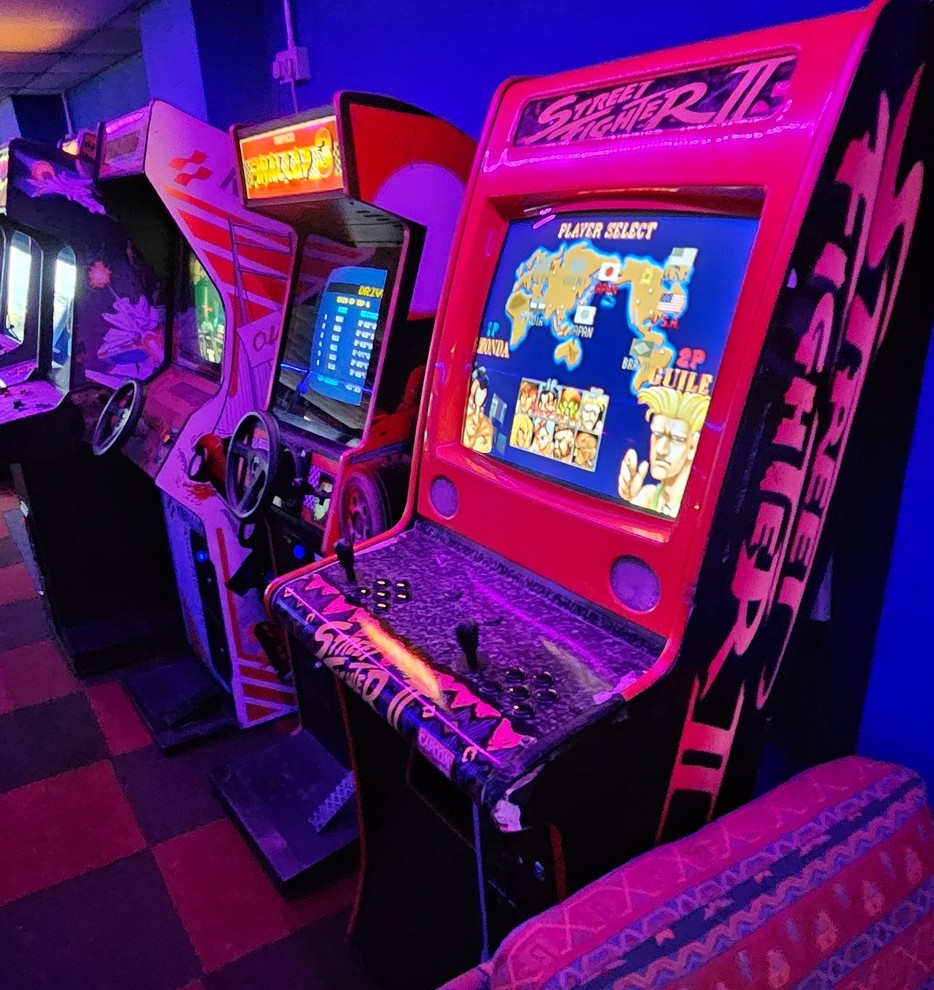 Street Fighter II cabinet with driving cabinets behind